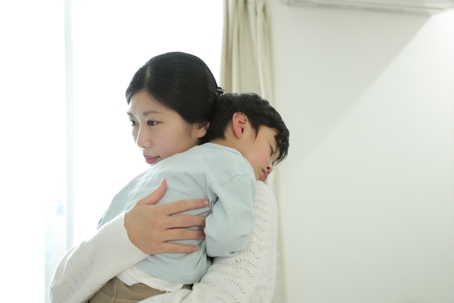 mother holding sick son