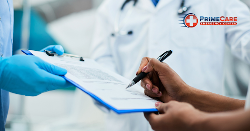 Person completing paperwork at an emergency medical center.